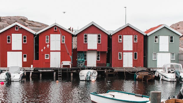 Charming red wooden houses line the waterfront in Smögen, Sweden, reflecting traditional Scandinavian architecture.