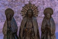 Detailed statue trio in Elche highlighting religious symbolism.