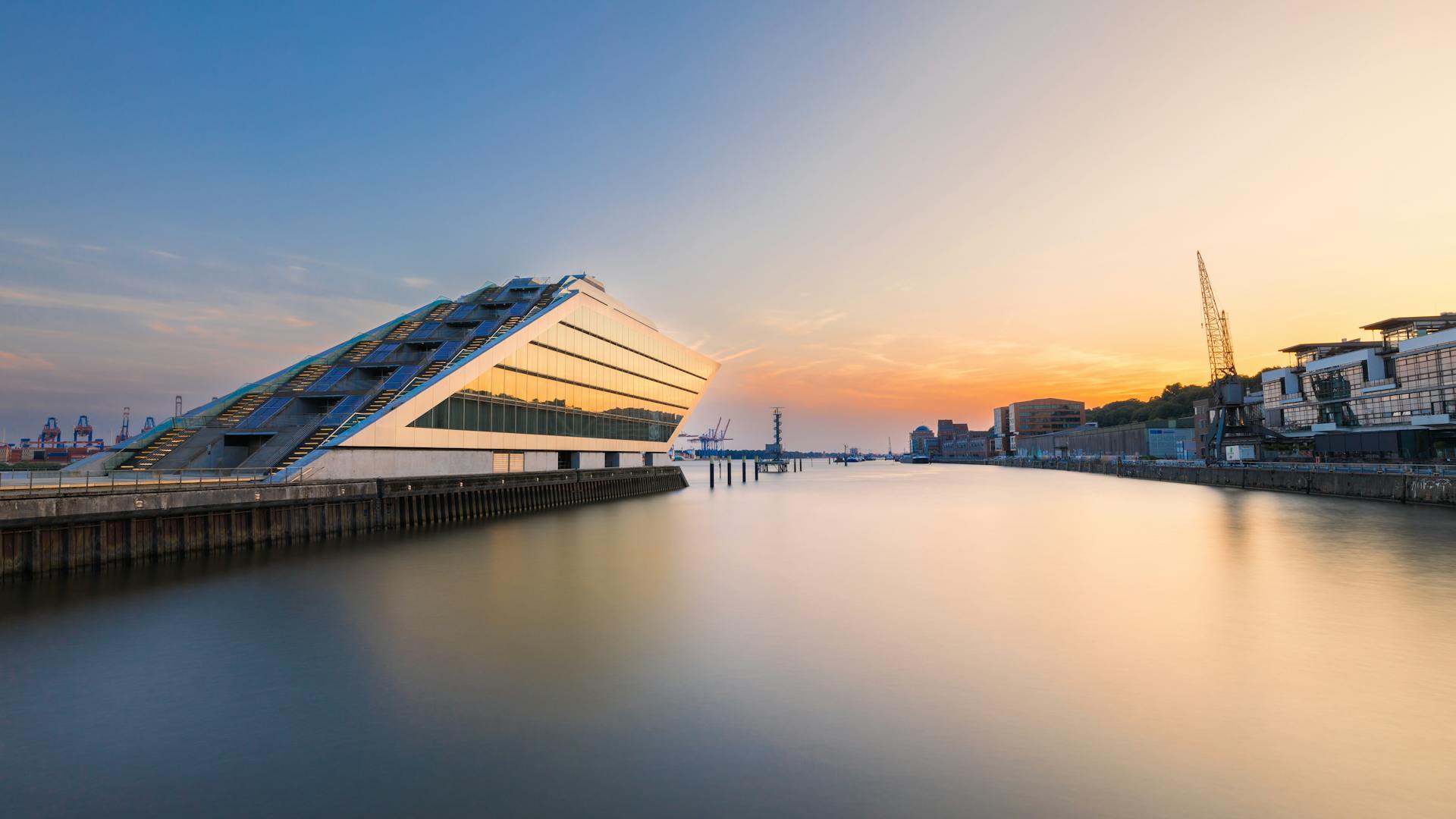 Sunset view of the iconic Dockland office building reflecting on the water in Hamburg.