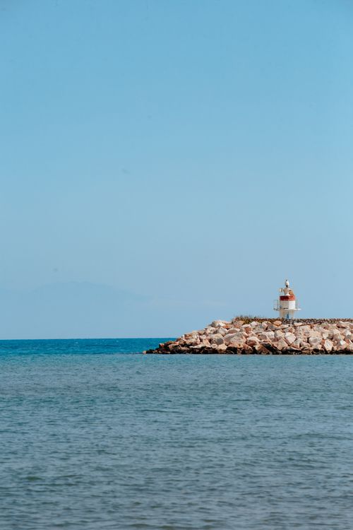 Free Peaceful coastal scene with a lighthouse in Adana, perfect for relaxation and travel imagery. Stock Photo