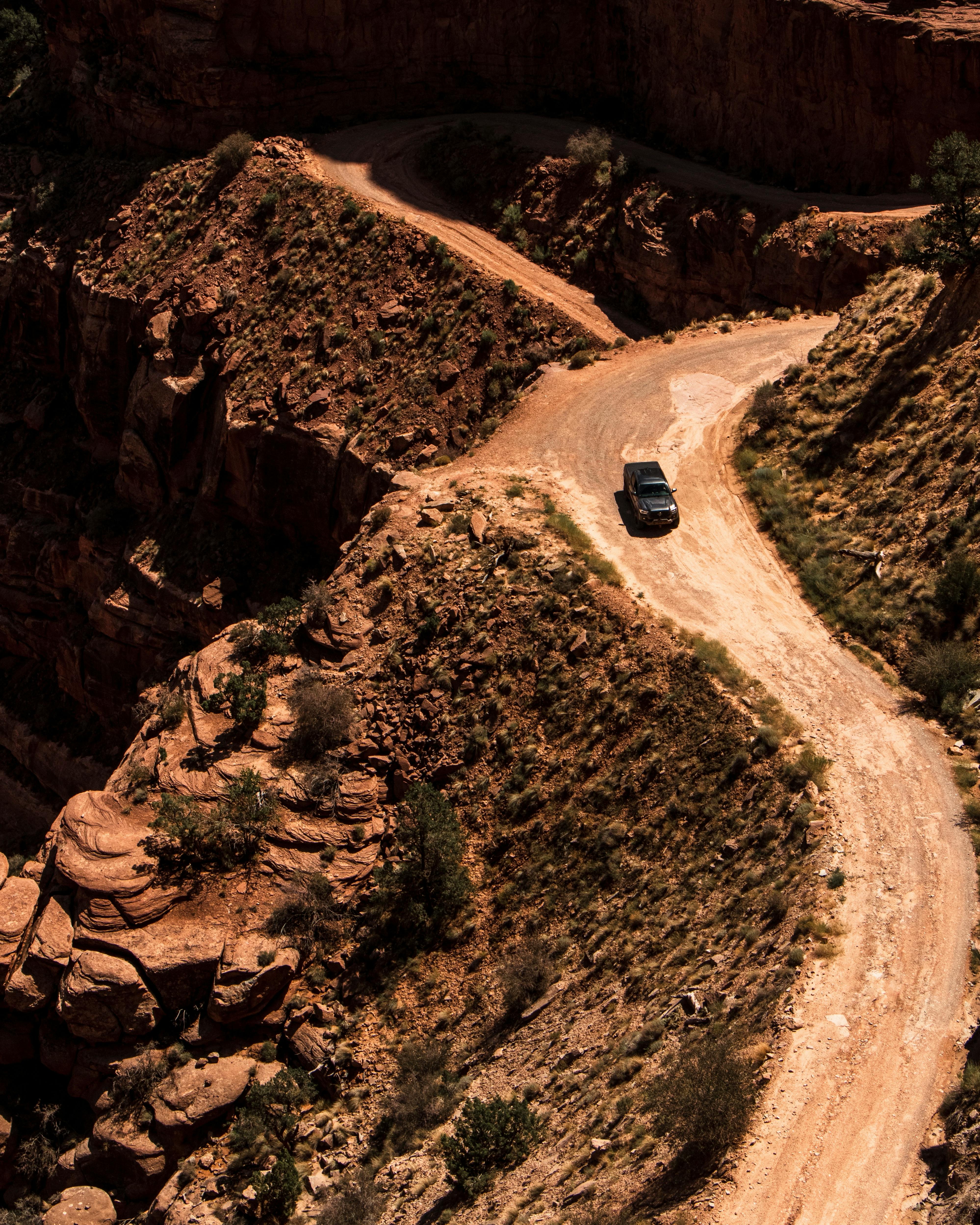 A rugged offroad journey through the stunning canyon landscapes of Utah on a dirt road.