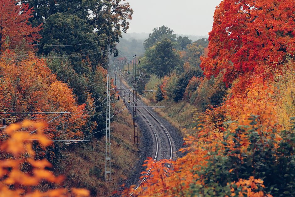 Beautiful autumn landscape in Jönköping, Sweden featuring vibrant foliage and a winding railway.