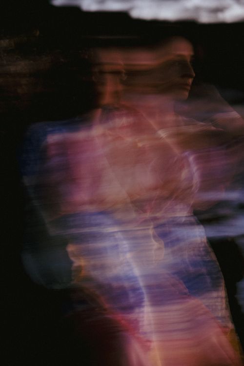 Free Artistic abstract image of a woman in motion with colorful blur effect. Stock Photo