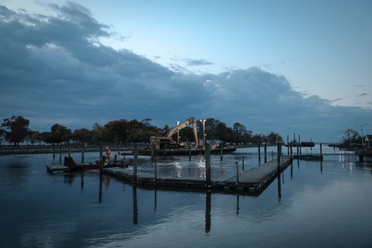 Scenic twilight view of dredging operations at Stamford Marina. Tranquil atmosphere.