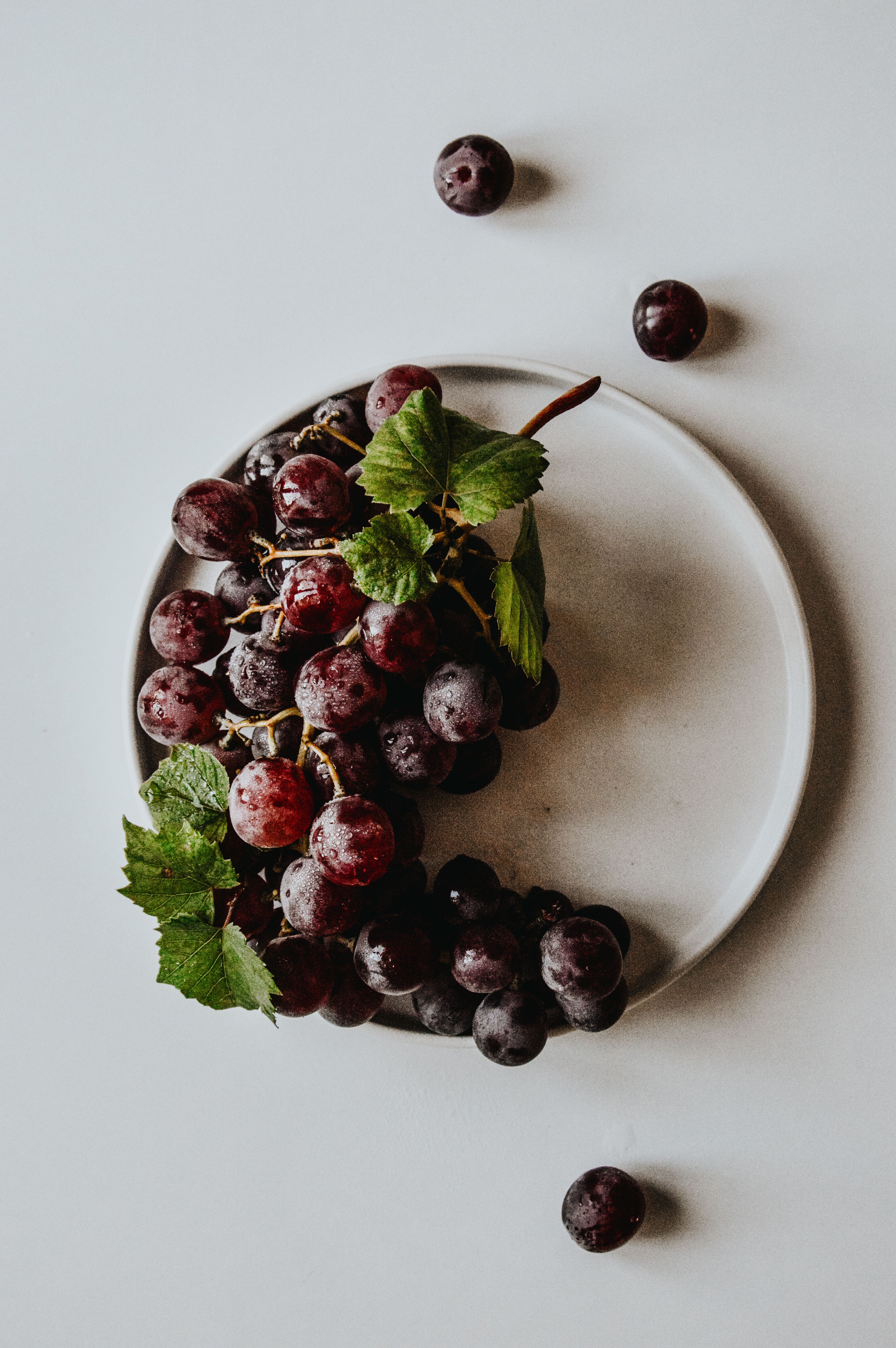 Flat Lay of Fresh Red Grapes on Plate · Free Stock Photo