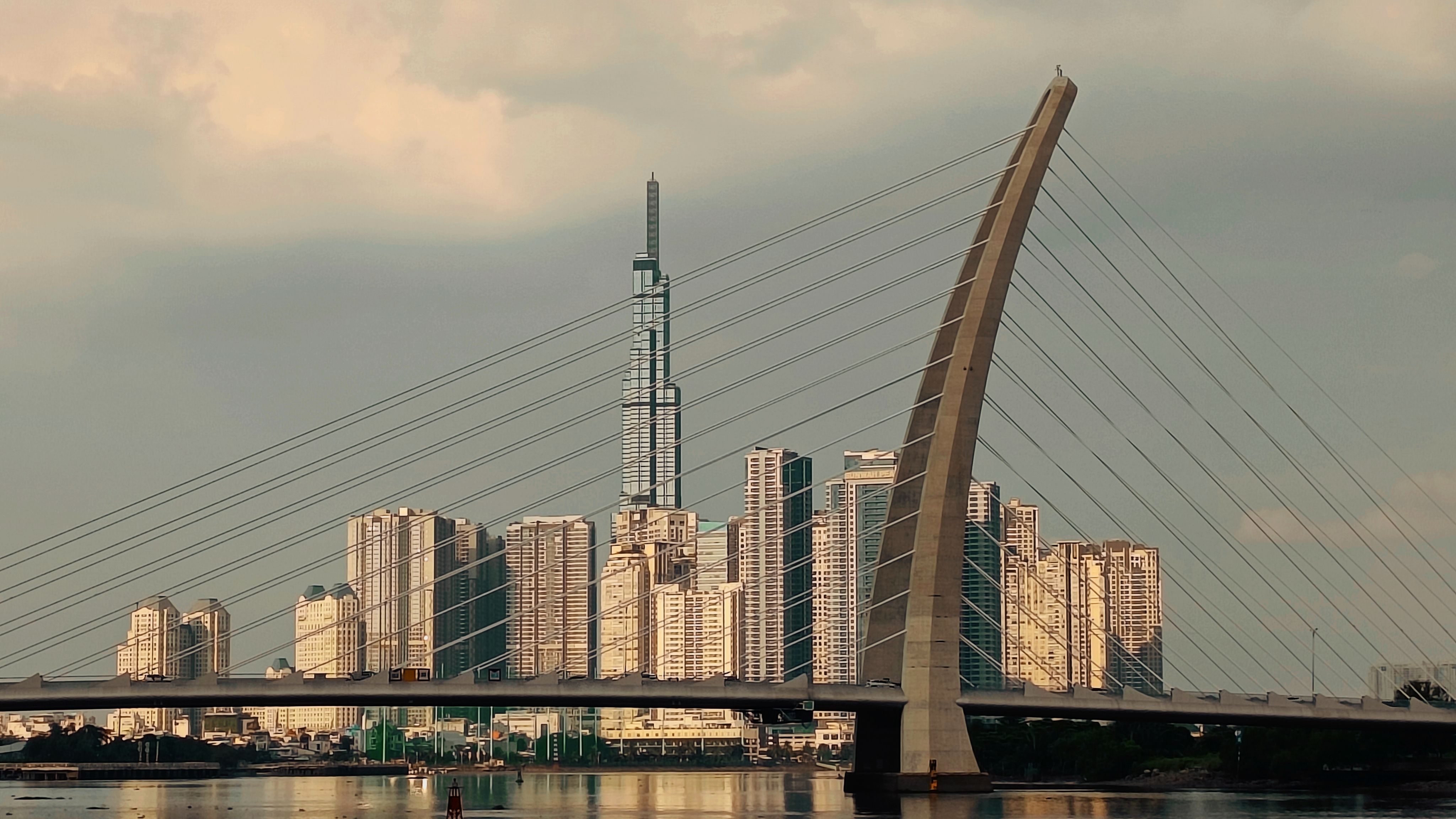 Cable-Stayed Bridge with Urban Skyline at Sunset · Free Stock Photo