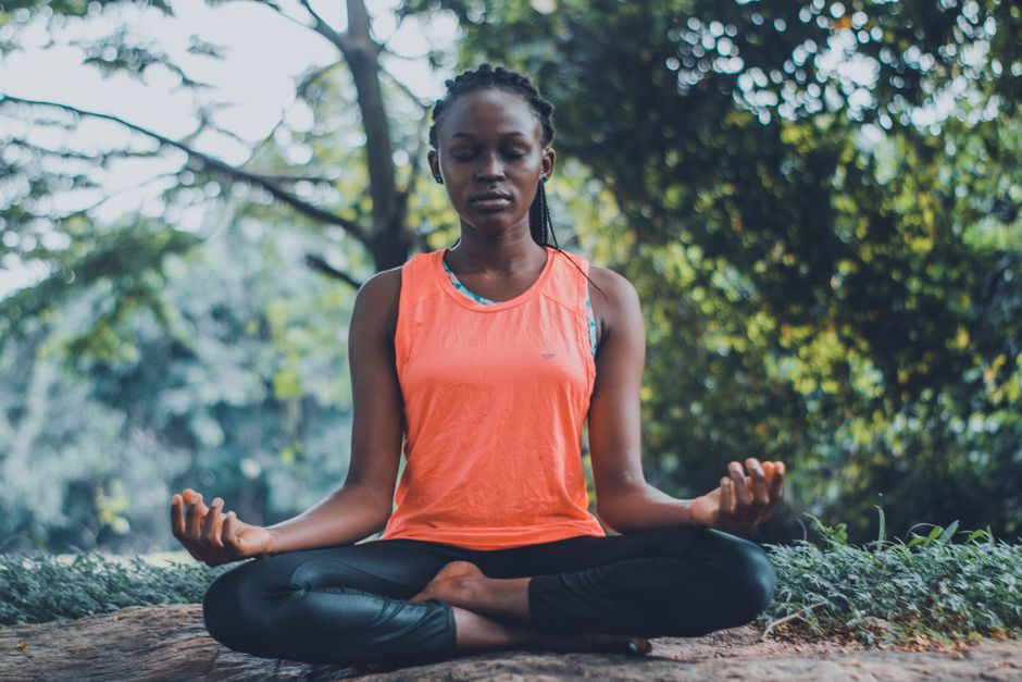 Woman meditating outdoors in nature — integration and lifestyle change are necessary alongside iboga microdosing for lasting results, and the practice is not appropriate for everyone