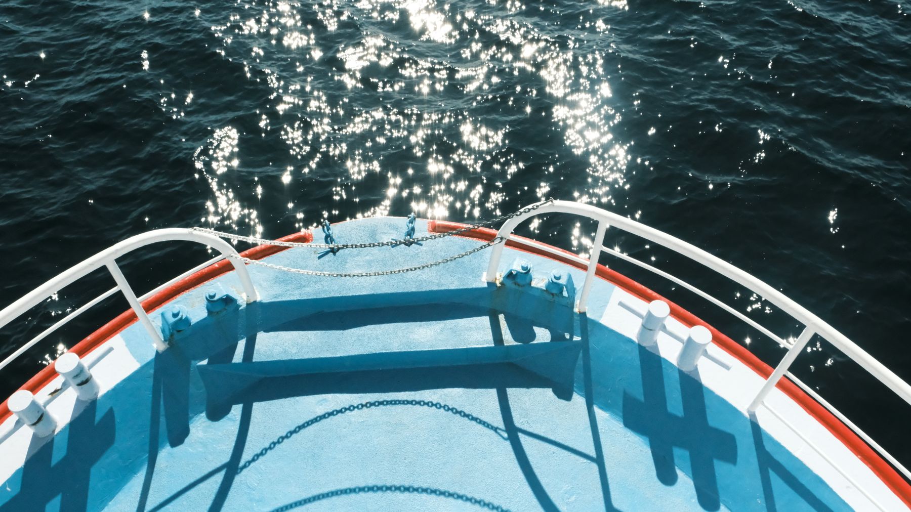 Bright open water viewed from a boat under strong sunlight