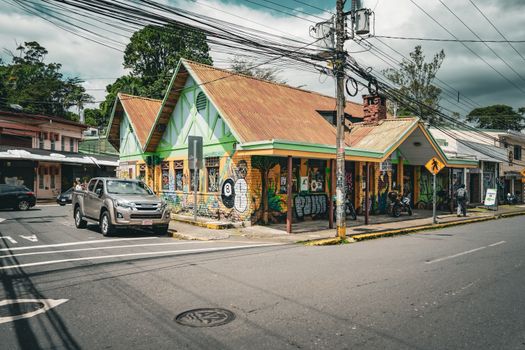 Street view of a colorful building with graffiti in San José, Costa Rica on a sunny day.