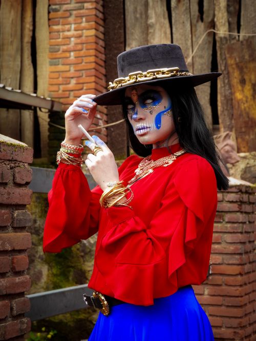 Free Striking portrait of a Catrina with traditional makeup and attire celebrating Day of the Dead. Stock Photo