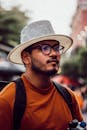 Young Man Outdoors with Stylish Hat and Glasses