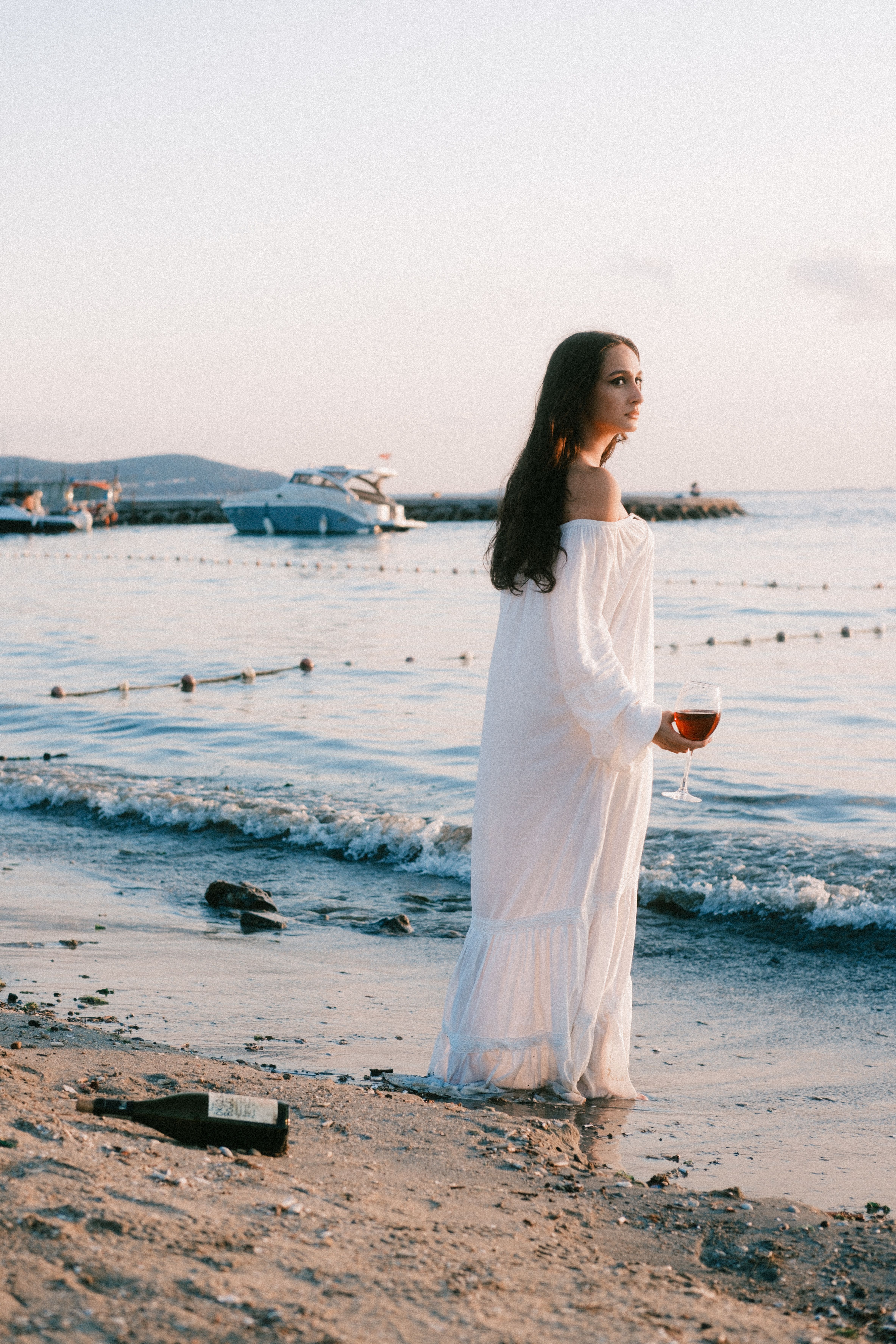 Woman in White Dress Strolling on Beach at Sunset · Free Stock Photo