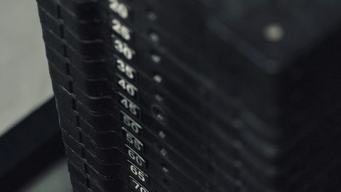 Detailed view of a weight stack on gym equipment for strength training workouts.