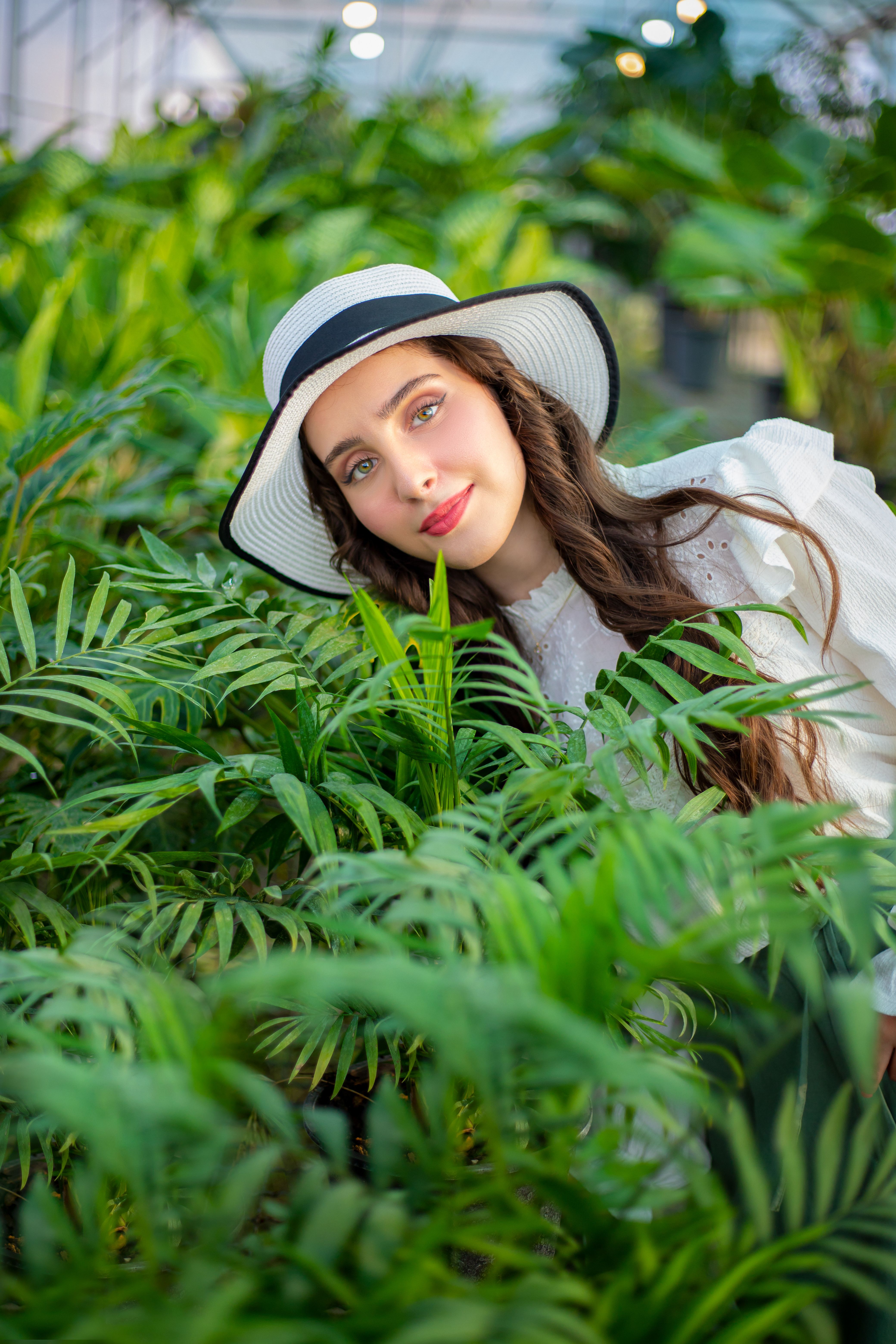 Woman with Hat Smiling in Greenhouse · Free Stock Photo