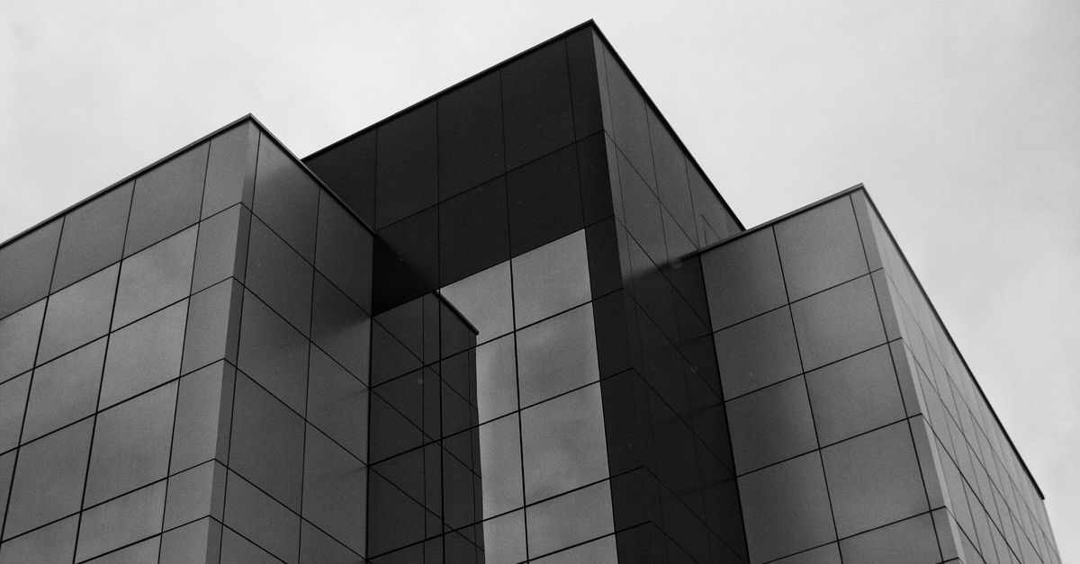 A modern, sleek photo of the HYBE headquarters building in Seoul, symbolizing industry power