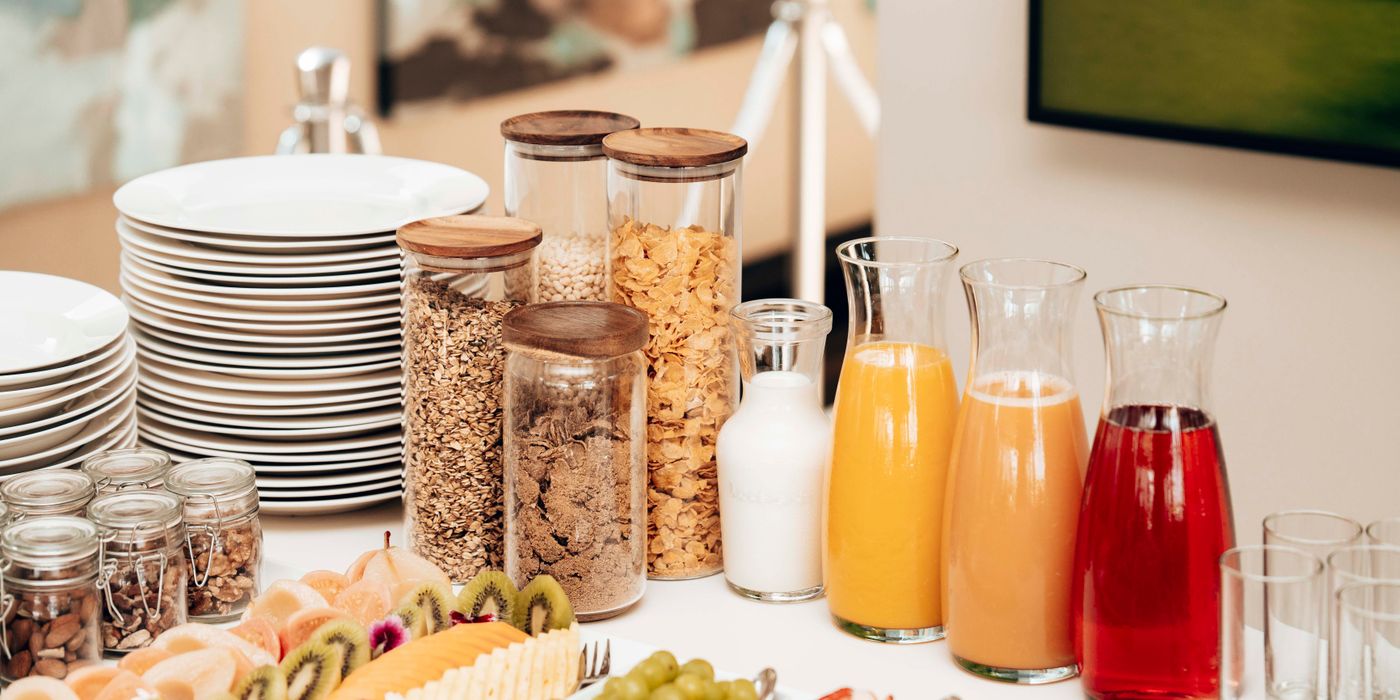 Assorted hotel breakfast buffet spread with juices and pastries