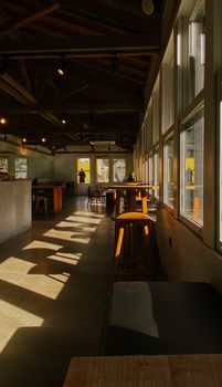 Warm, inviting café interior with sunlit wooden accents and modern design.