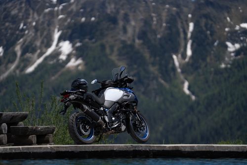 Free A motorcycle parked by a mountain view, ideal for travel and adventure themes. Stock Photo