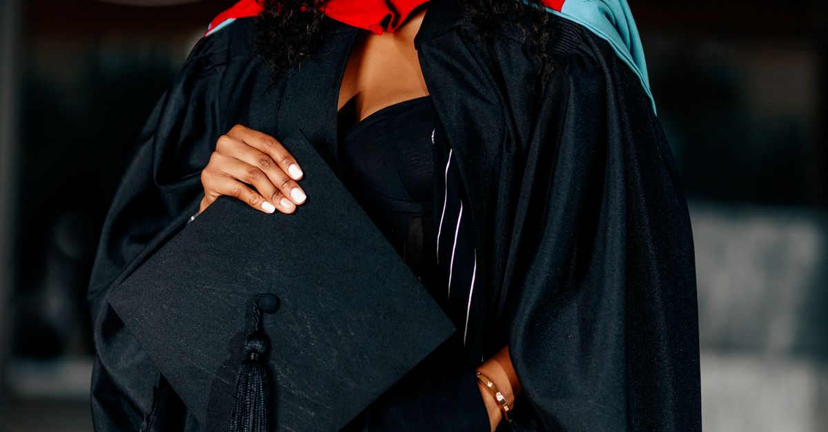 Graduate Def University Graduate Celebrating in Cap and Gown · Free Stock Photo