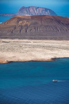 Stunning aerial view of Lanzarote's rugged landscape and deep blue ocean.