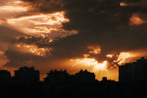 Free A vibrant orange sunset with dramatic clouds over the Berlin cityscape. Stock Photo