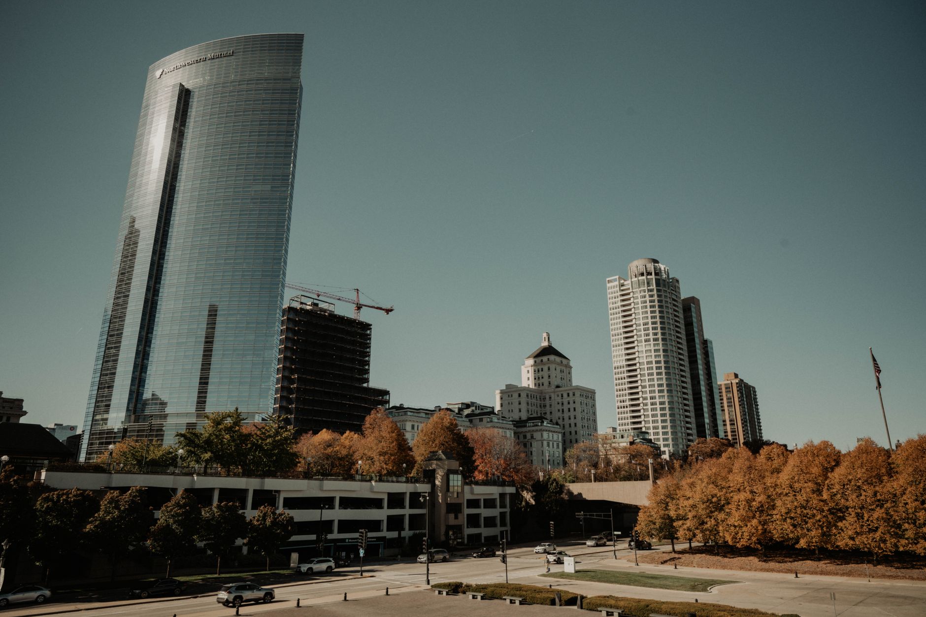 Stunning view of Milwaukee skyline with modern skyscrapers and fall foliage, highlighting urban growth.