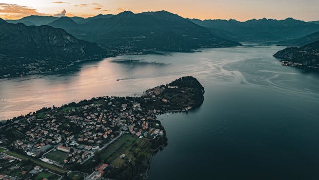 Stunning aerial view of Bellagio, Italy at sunset, showcasing Lake Como and the surrounding mountains.