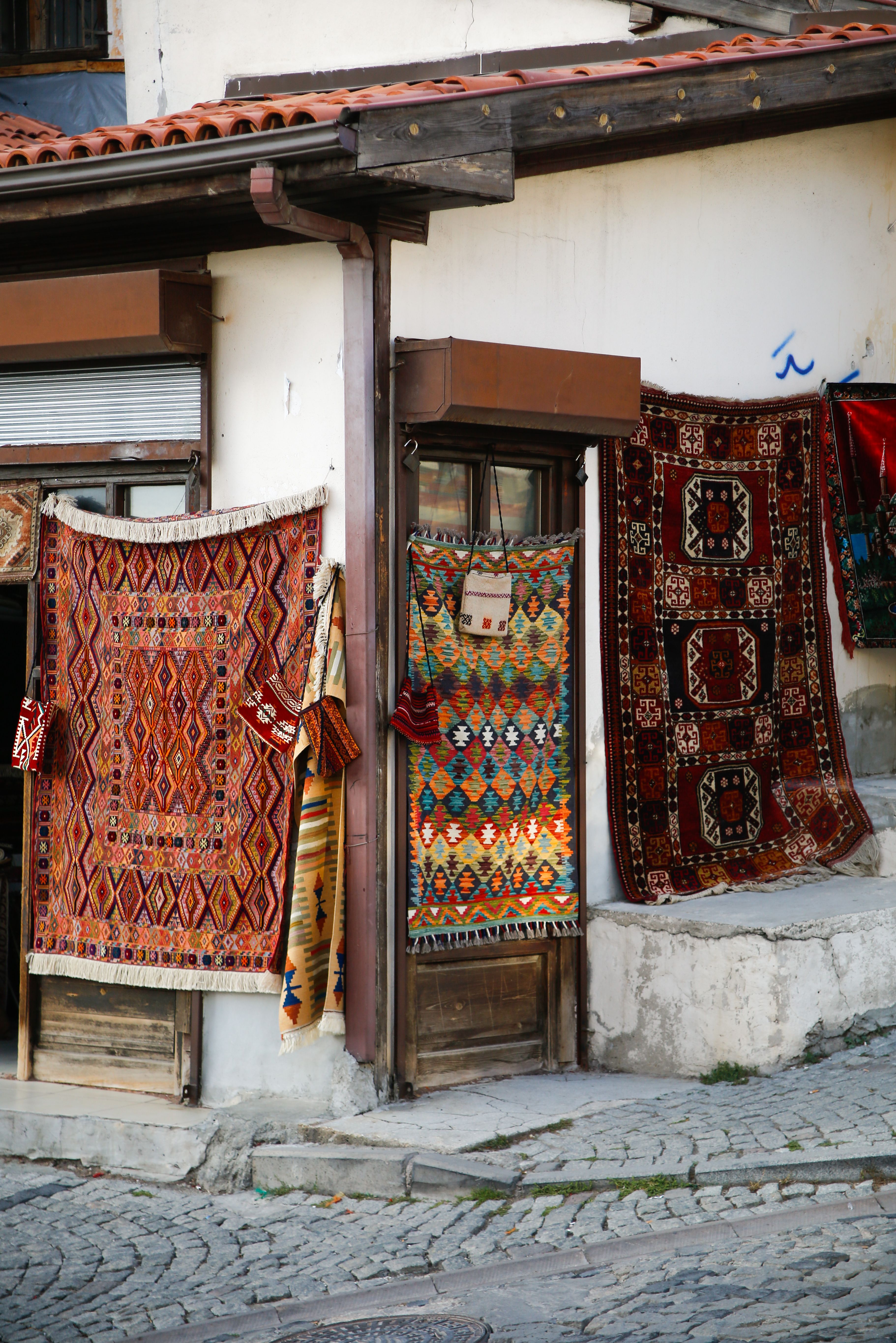 Colorful Traditional Rugs Displayed Outdoors · Free Stock Photo