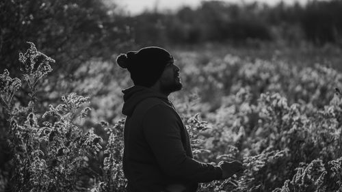 Free Silhouette of a man enjoying a peaceful autumn landscape in black and white. Stock Photo