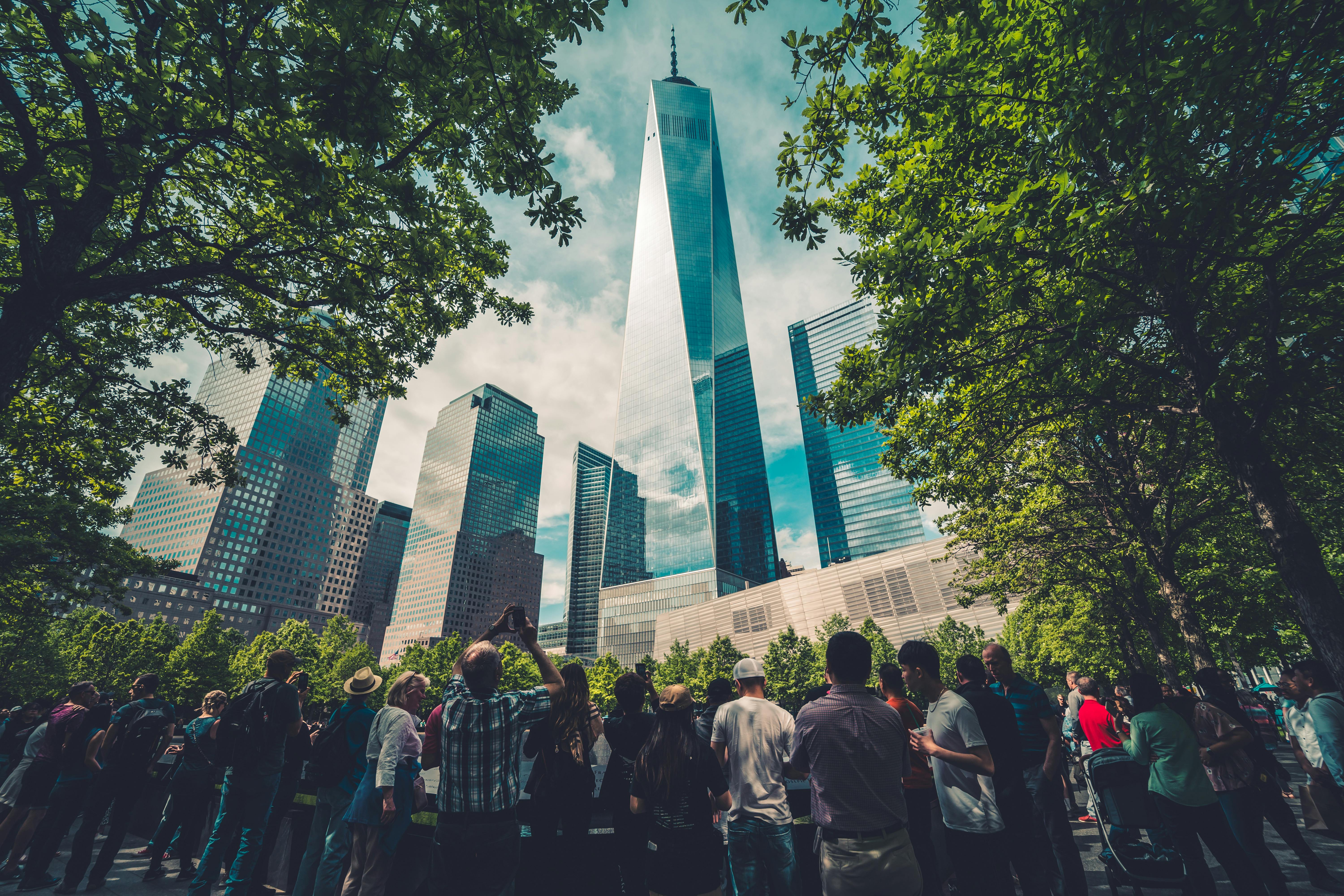 people standing across glass building