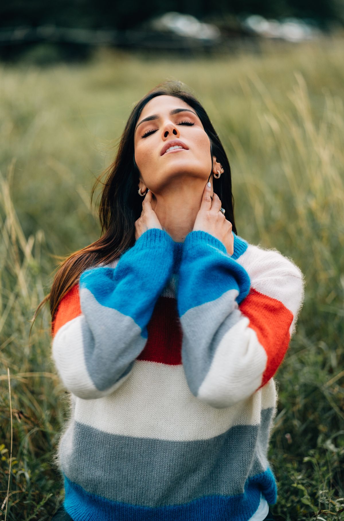 Woman styled in a neutral sweater as a standalone outfit piece