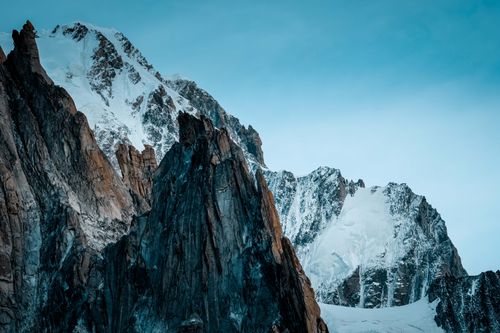 Free Stunning snow-capped mountain peaks under a clear blue sky. Perfect for nature photography lovers. Stock Photo