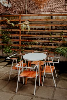 Stylish modern outdoor patio set featuring wooden chairs and plants. - Fotografer Sidoarjo