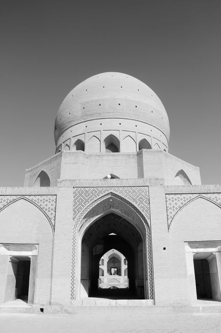 Black and white photo showcasing an ancient Islamic dome with geometric designs.