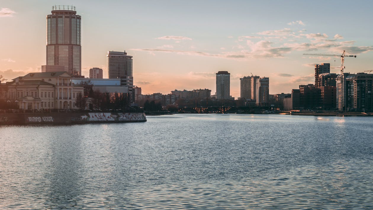 Photo Of Buildings Beside Waterfront During Dawn