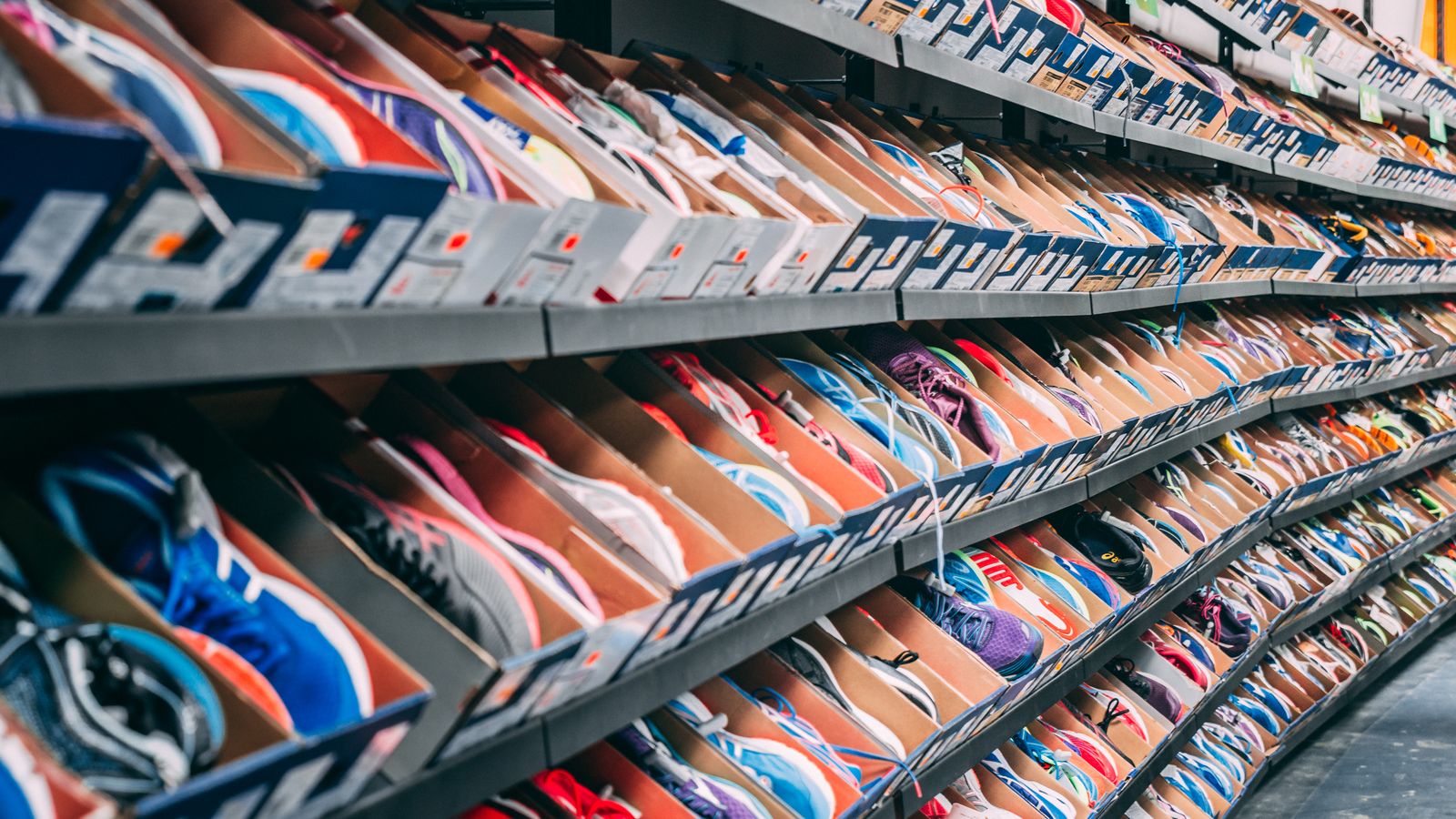 Shoes stored in clear boxes stacked on a shelf