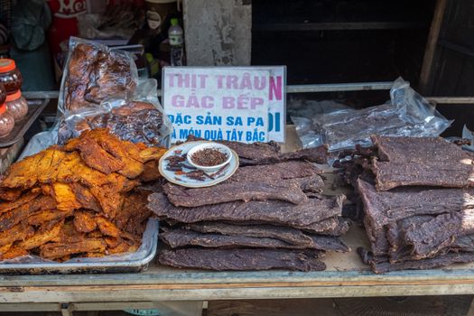 Dried buffalo meat showcased at a market stall in Sa Pa, Vietnam, highlighting traditional local delicacies.