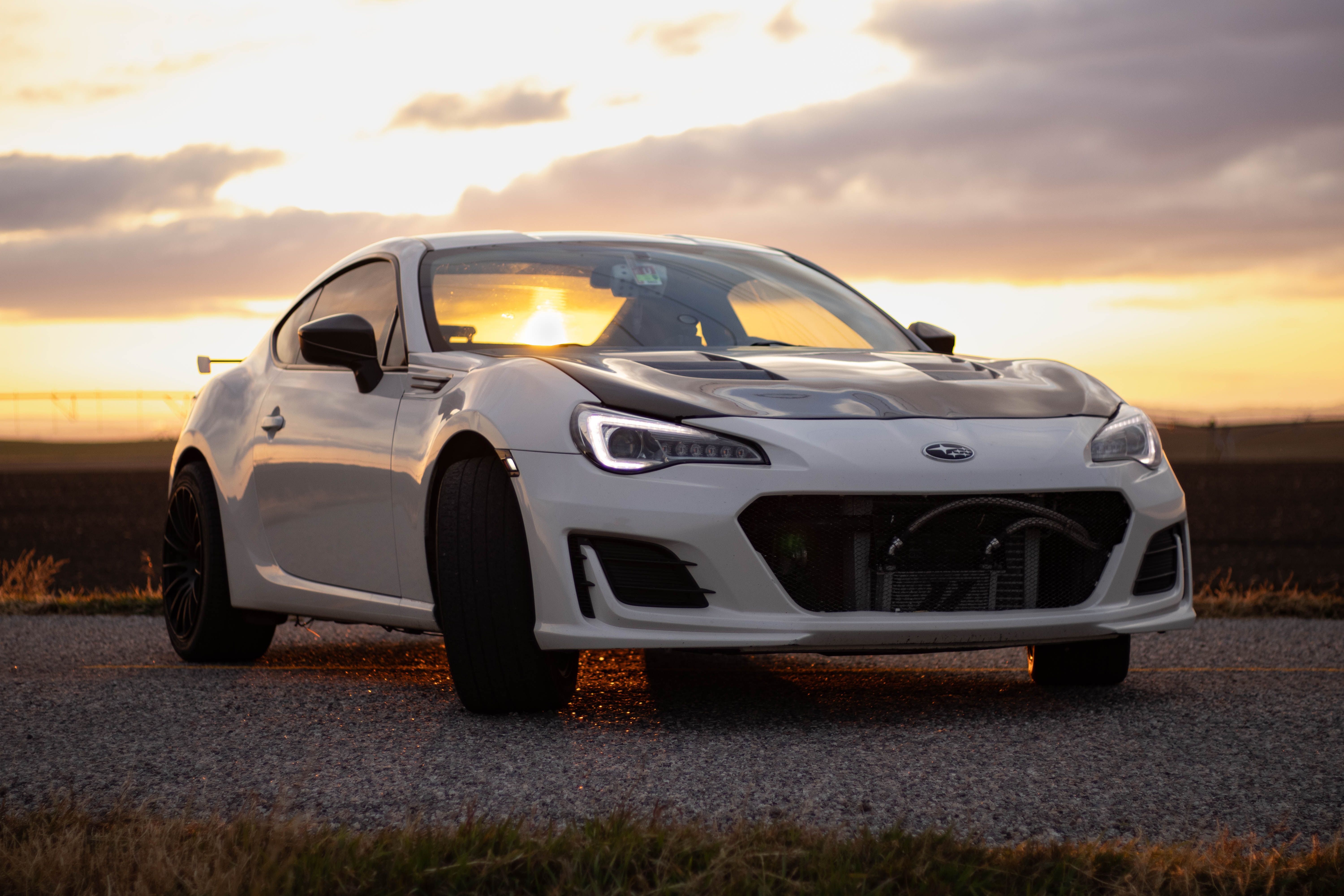White Sports Car at Sunset on Open Road · Free Stock Photo