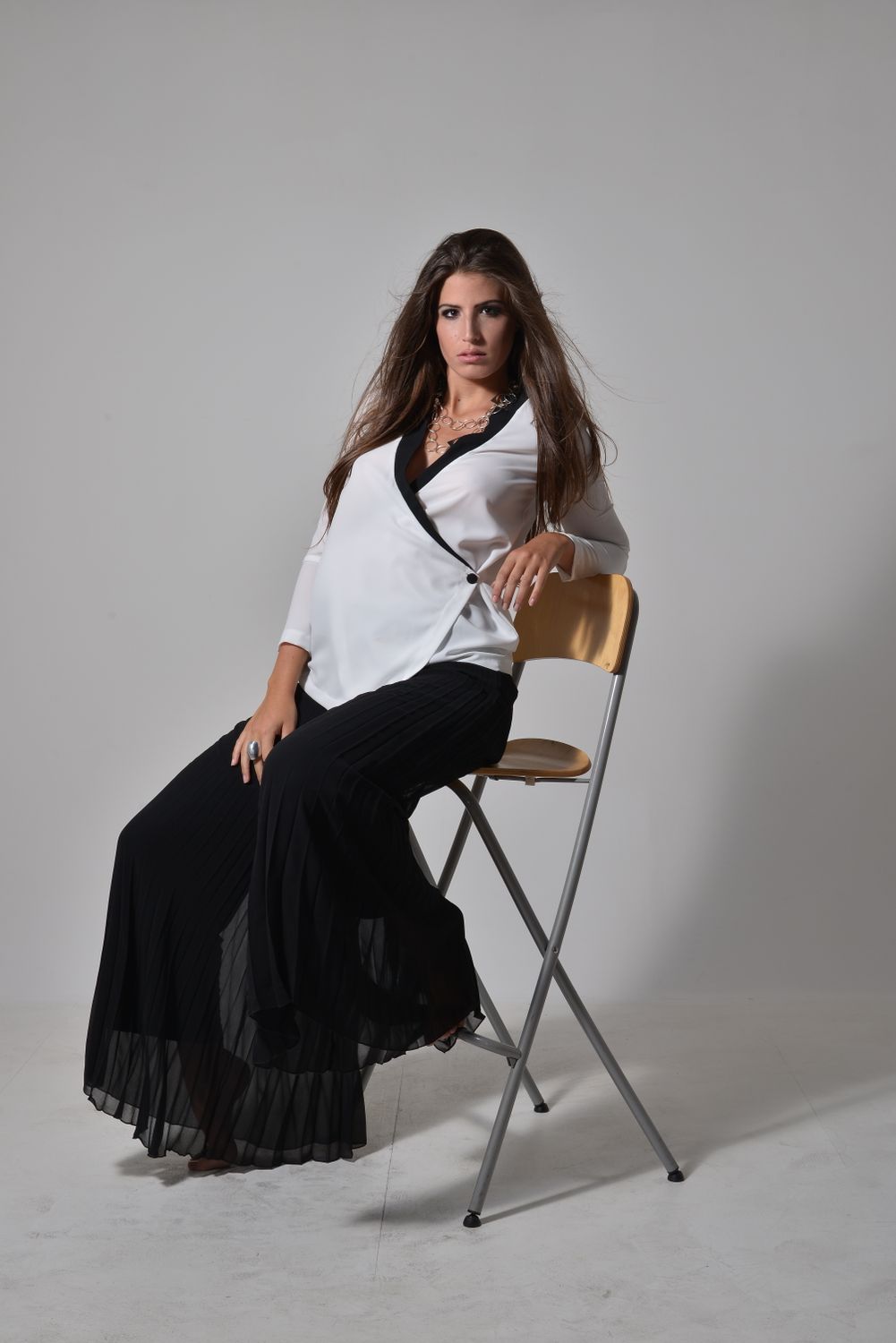 Elegant Woman Seated on Wooden Chair in Studio · Free Stock Photo