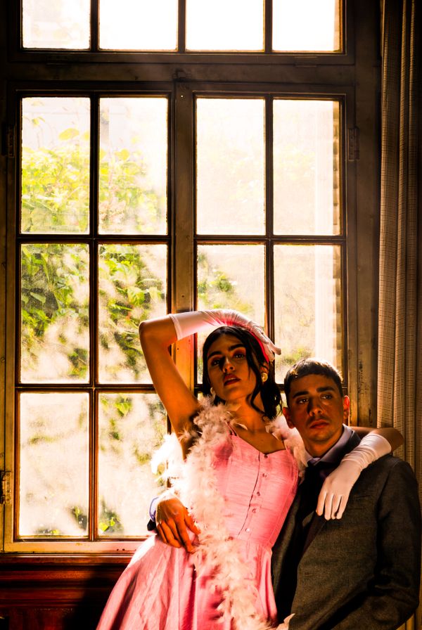 Vintage-styled pair by a sunlit window by Lucas Agustin on Pexels