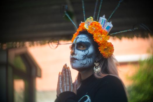 Vibrant Day of the Dead Catrina with floral crown in Mexico City parade.