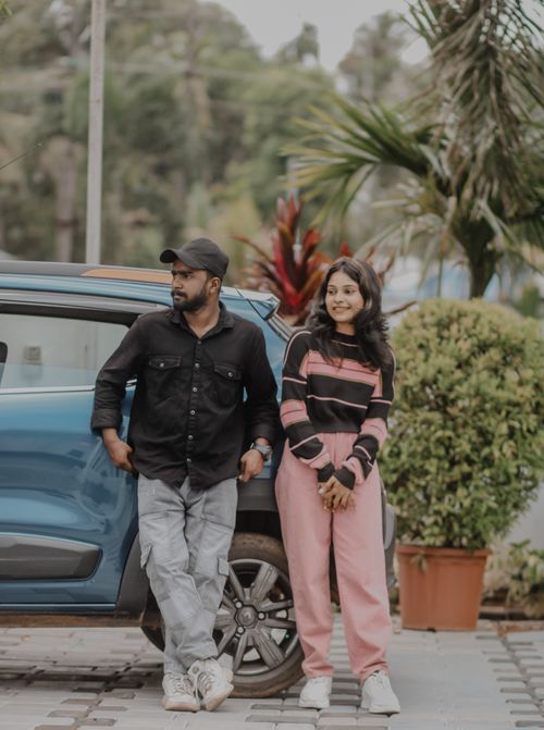 Free Two friends relaxed by a car on a sunny day in Muvattupuzha, Kerala, India. Stock Photo
