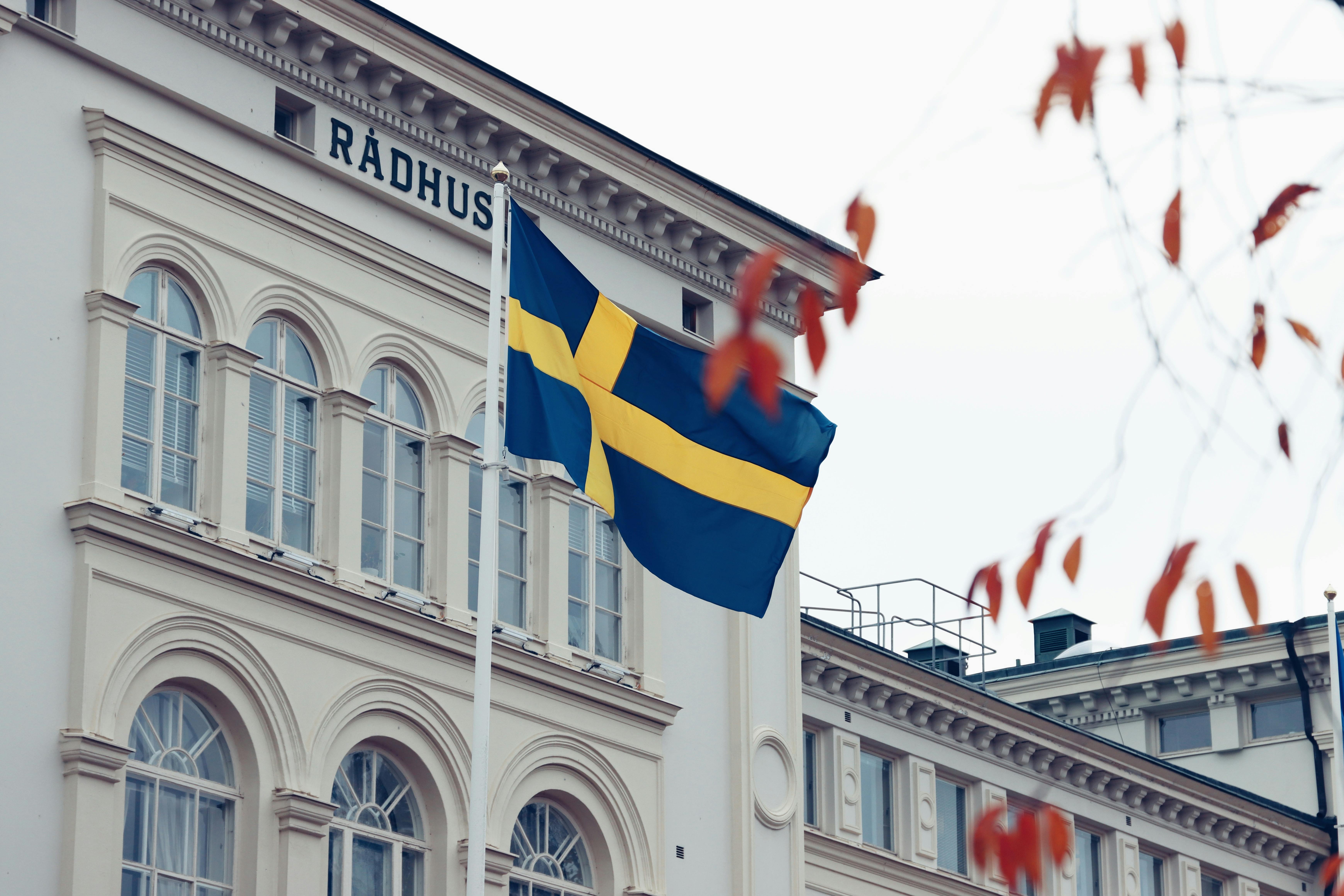 swedish flag on historic radhus building in jonkoping