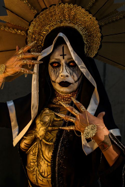 Free A striking portrait of a person in elaborate Day of the Dead attire, with dramatic makeup and accessories. Stock Photo