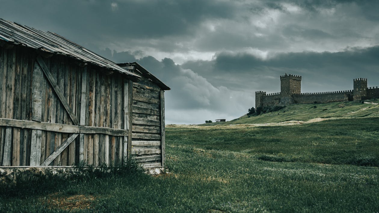 Gray Wooden Barn Under Cloudy Sky