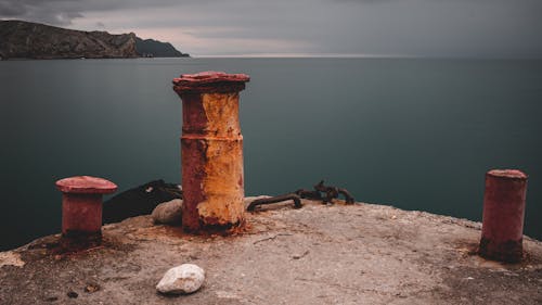 A Rusty Metal Boat Post On A Dock