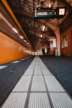 Berlin U-Bahn train speeds through an iconic station, capturing urban movement.