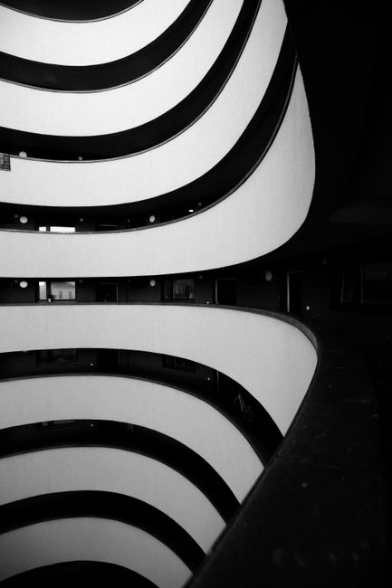 Explore Berlin's sleek modern architecture with this stunning black and white photo capturing curved structures.