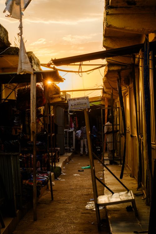Free A sunlit market alley with shoppers during golden hour. Captures rustic charm. Stock Photo