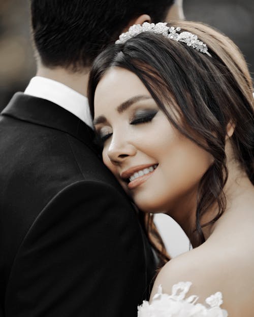 Close-up of Smiling Bride With Her Eyes Closed Hugging Groom